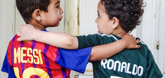 Two boys with jersey from Lionel Messi and Cristiano Ronaldo